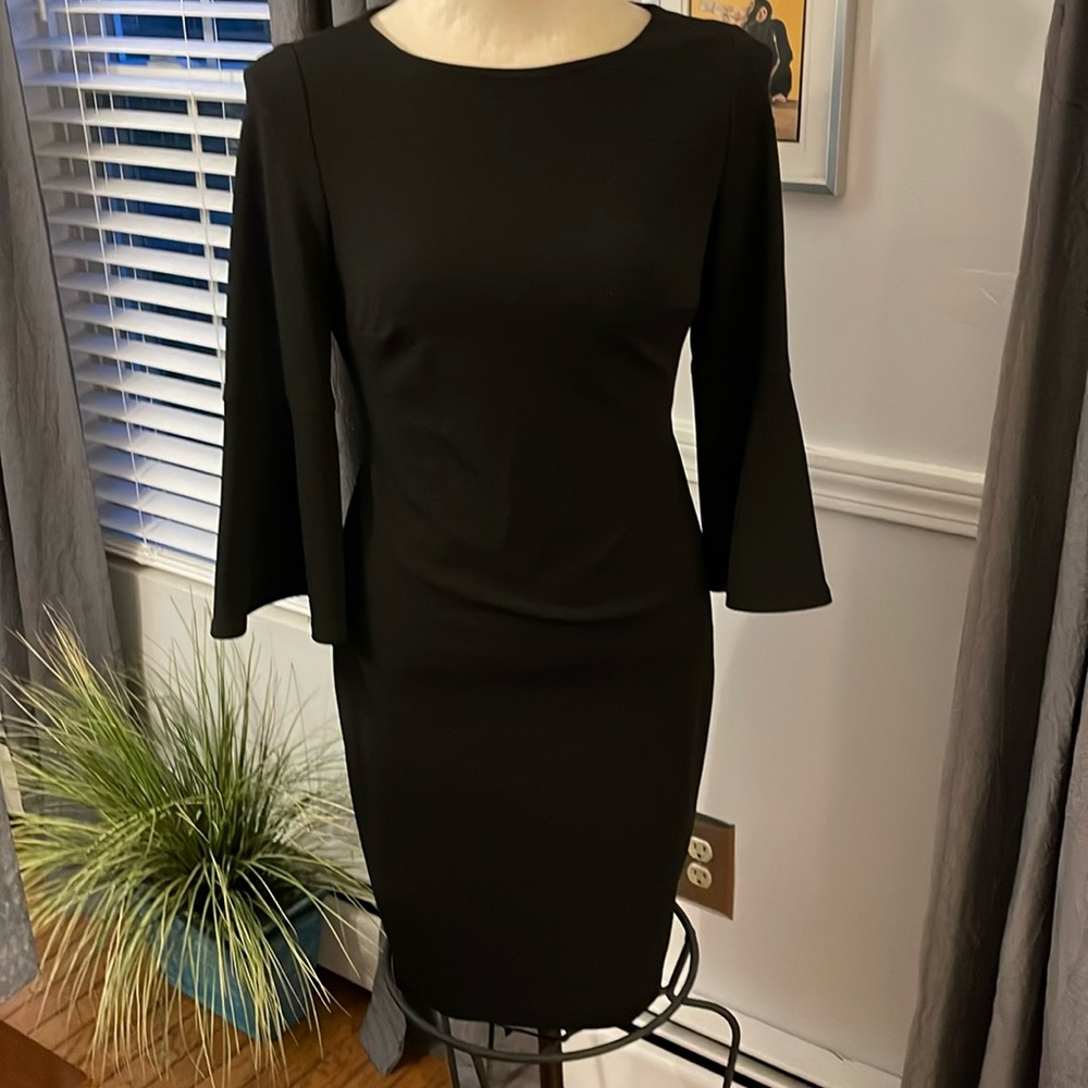 Calvin Klein black peplum dress with gold zipper down the back.  Size 6